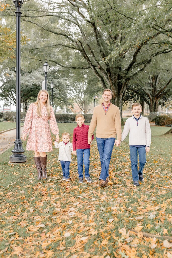 Roswell photographer - Fall family photos in downtown Roswell, GA, happy family walking toward camera